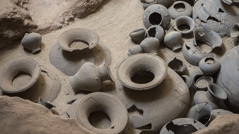Ancient Sangkhalok ceramic vessels partially excavated at a Sukhothai kiln archaeological site