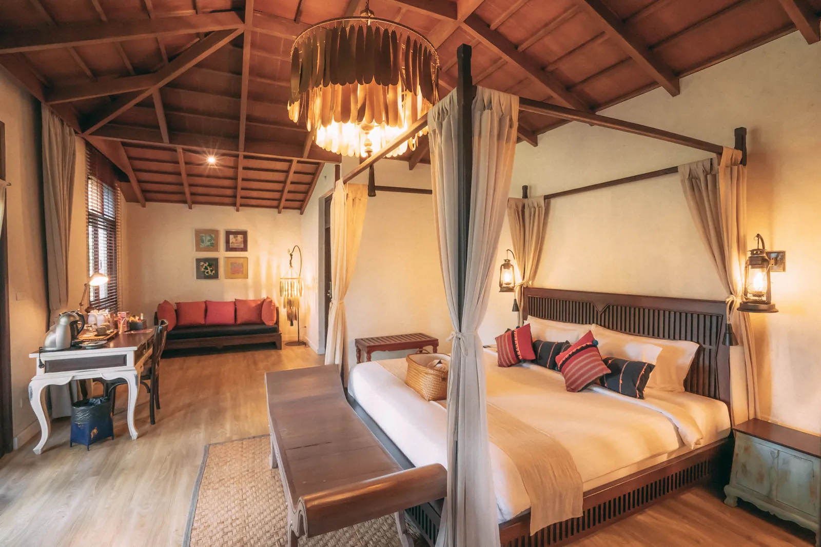 Sriwilai Suite — generous bedroom with terrace overlooking the lotus pond and temple ruins at dusk